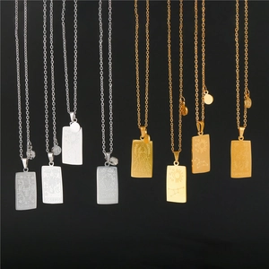 Vintage stainless steel zodiac tarot necklaces in gold and silver hanging on black backdrop