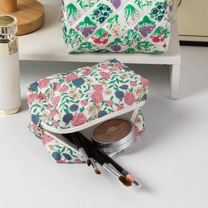 Quilted floral cotton cosmetic bags showing large storage capacity and metal zipper closure