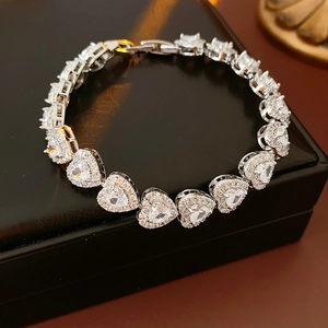 Detailed view of silver heart bracelet with sparkling zircons on black jewelry box