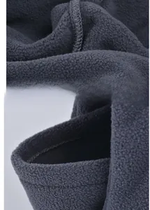 Macro shot of dark grey fleece fabric with high-density flatlock stitching detail