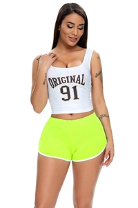Front view of white crop top and neon green yoga shorts set with elastic knit fabric