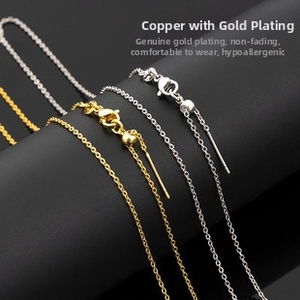 Detail of gold and silver plated copper chains with lobster clasps on display
