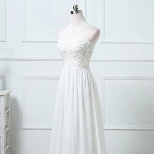 Elegant white strapless A-line wedding gown with floral lace bodice and flowing chiffon skirt