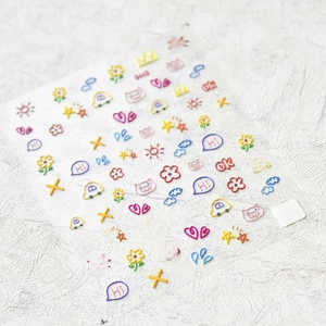 Detailed macro shot of 5D embossed colorful graffiti nail stickers with cartoon icons