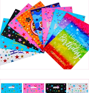 Close-up of colorful plastic birthday gift bags with stars and festive patterns