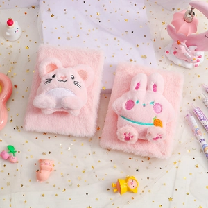 Detailed view of two soft pink plush journals featuring cute rabbit and mouse characters