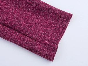 Close-up of deep pink tweed sleeve cuff showcasing intricate fabric weave and texture