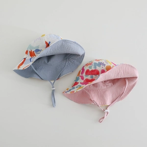 Detail of kids reversible sun hat with colorful graffiti print and adjustable chin strap