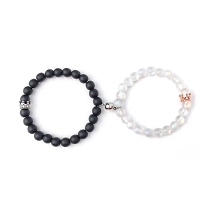 Macro detail of magnetic couples bracelets with matte black and translucent stone beads