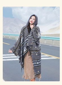 Detail of grey geometric pattern hooded shawl with tassels for outdoor travel