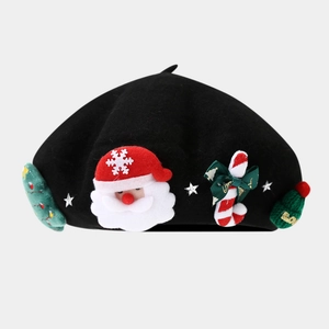 Close-up of black wool beret with Santa Claus and Christmas tree felt decorations