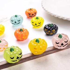 Colorful Halloween glow-in-the-dark mini resin pumpkin figurines in various expressions