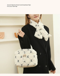 Close-up of fluffy white fleece handbag and scarf set with black bow patterns