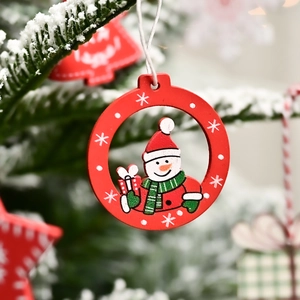 Hand-painted wooden Christmas ornament featuring a snowman hanging on a snowy pine tree branch