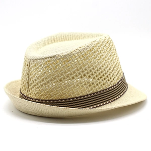 Detail of breathable hollow weave and striped ribbon on summer straw fedora hat