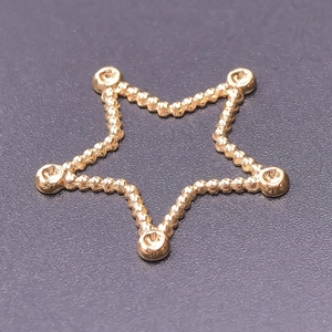 Macro shot of 18k gold plated stainless steel star pendant with beaded edges and connector