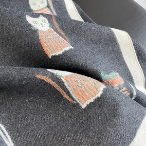 Detailed close-up of high-density jacquard knit scarf with colorful cat illustration