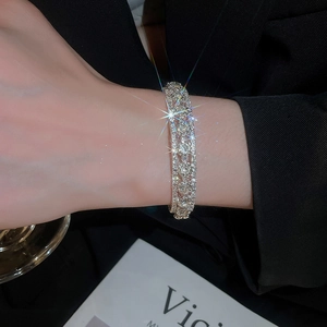 Macro view of triple-layered silver bracelet with brilliant cubic zirconia stones