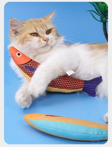 Close-up of realistic catnip fish toy with detailed scales being held by a cat