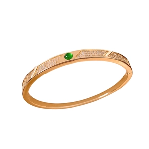 Vintage 18K gold plated bangle with green gemstone and diamond accents on white background