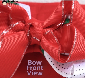 Macro shot of layered red grosgrain ribbon bow with glitter edges and polka dot detail