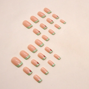 French press-on nails in grass green with cute strawberry designs and square shape