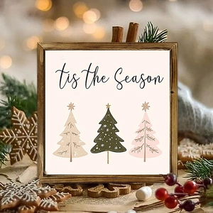 Detail of wooden Christmas sign with tis the Season text and three colorful trees
