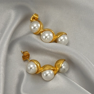 Elegant gold stainless steel pea-shaped earrings with three white pearls on grey silk