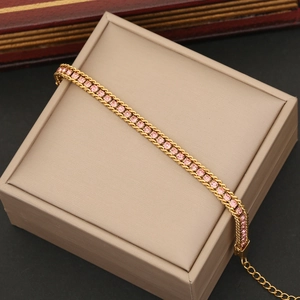 Detail of gold chain bracelet with pink round cubic zirconia and adjustable extender