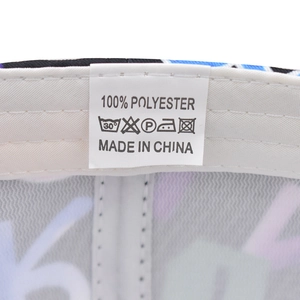Detail view of the 100% polyester fabric care label and washing symbols on the baseball cap