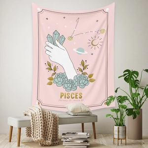 Detailed view of Pisces astrology tapestry with crystal and moon on a pink wall