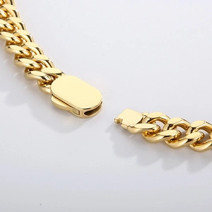 Macro detail of a high-quality gold Cuban chain necklace with a secure snap-lock buckle