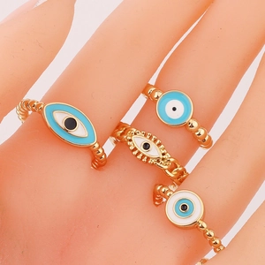 Gold evil eye ring set for women with turquoise enamel and crystal details on fingers