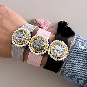Set of three Saint Benedict woven bracelets in grey, pink and black with pearl details