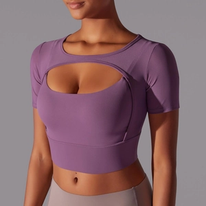 Macro view of purple cropped yoga top featuring mesh stitching and hollowed-out chest design