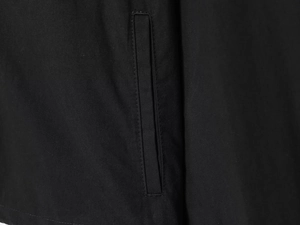 Macro detail of high-quality stitching on black nylon puffer jacket pocket edge