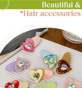 Detail of candy-colored acetate heart hair clips with sparkling rhinestone inlay