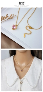 Detailed view of pink heart pendant with gold chain and lobster clasp closure