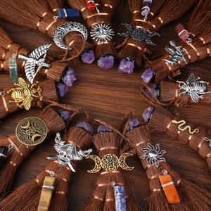 Mini Wicca broom car pendants with natural crystals and celestial charms on dark wood