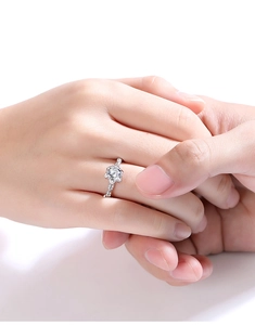 Close-up of S925 sterling silver ring with floral moissanite setting on a hand