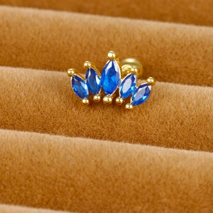 Golden crown cartilage stud earring with royal blue marquise zircon on velvet tray