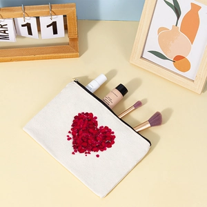 Canvas makeup bag with red heart rose print and black zipper showing storage use
