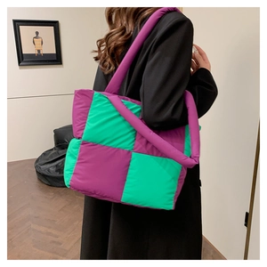 Macro shot of puffy tote bag with purple and green contrast checkerboard quilting