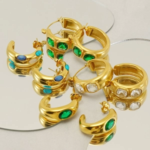 Detail of 18k gold plated chunky hoop earrings with emerald green and turquoise gemstones