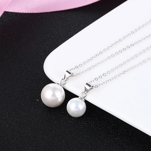 Minimalist S925 silver necklace with white pearl pendants in two sizes on a silver chain