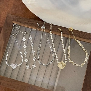 Close-up of star and heart charms on adjustable bracelets in gold and silver finish