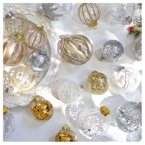 Detailed close-up of champagne Christmas ornaments with glitter and snowflake patterns