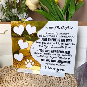 Detail of acrylic Mother's Day plaque with golden heart and text on a woven mat