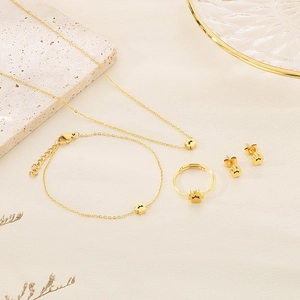 Detail view of a gold cat paw jewelry set with necklace, bracelet, ring and earrings