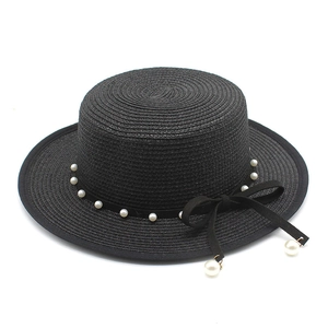 Women's black straw boater hat with pearl trim and velvet ribbon bow decoration